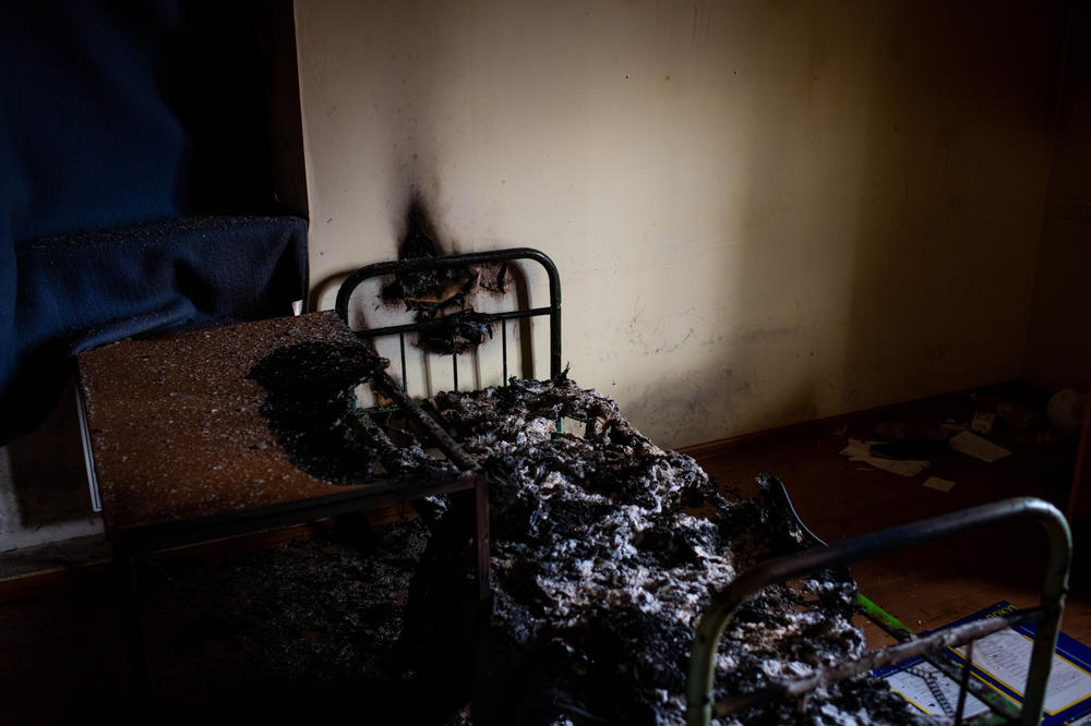 A burned cot in a police station that Kherson residents say Russians used to detain and torture violators of curfew and people suspected of collaborating with Ukrainian authorities.