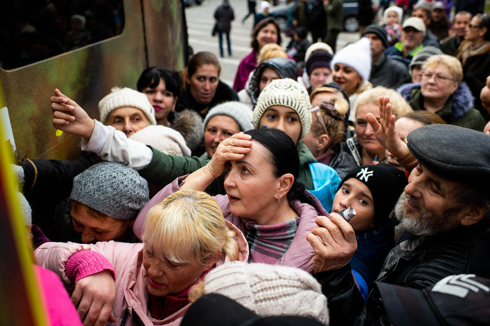 People crowd around a truck distributing medical aid in Kherson on Wednesday.
