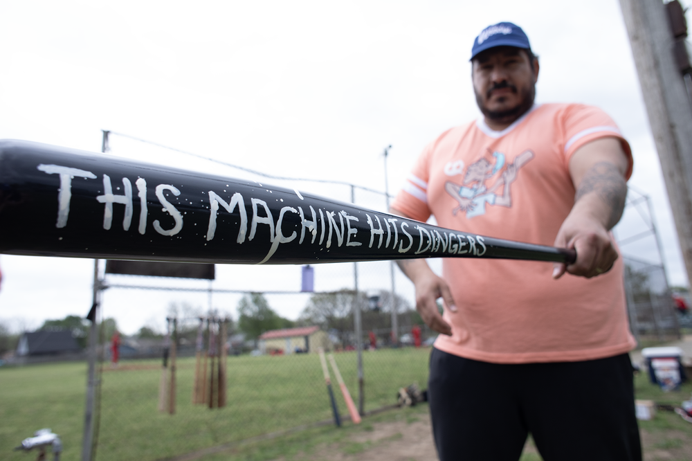 Chris Castro of the Oklahoma City Woodys shows off his bat, a gift from the Jesters, a Tulsa sandlot team.