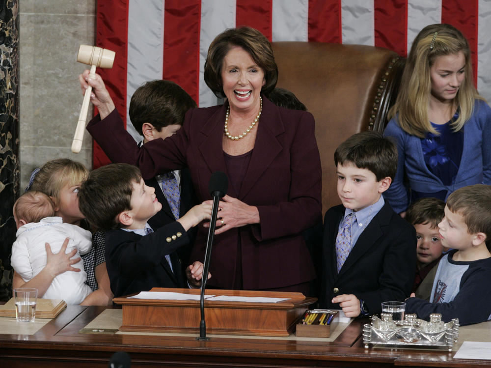 Nancy Pelosi holds up the gavel surrounded by children and grandchildren of members of Congress on Jan. 4, 2007, just after she was first elected House speaker.