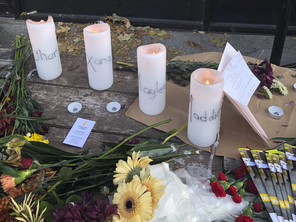 Candles and flowers are left at a makeshift memorial honoring four slain University of Idaho students outside the Mad Greek restaurant in downtown Moscow, Idaho, on Tuesday.