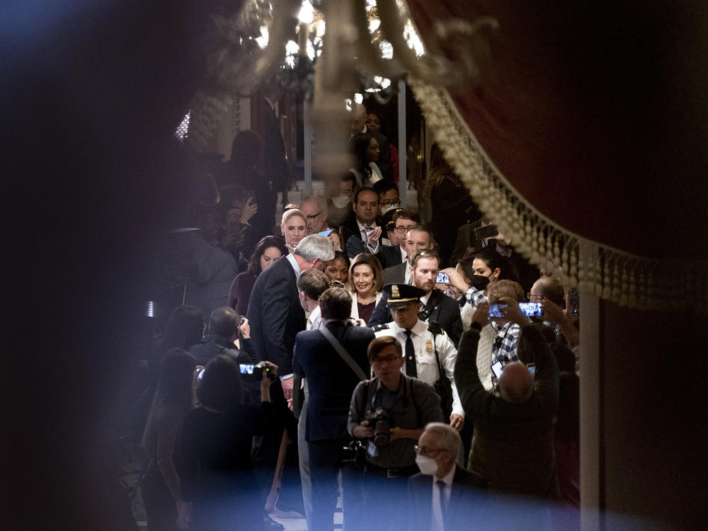 House Speaker Nancy Pelosi of California is surrounded by members of the media as she heads back to her office after announcing she would step away as a party leader.