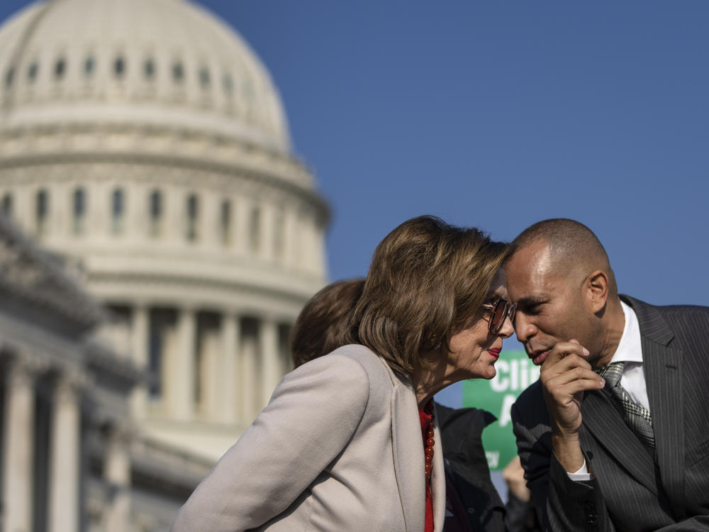Speaker of the House Nancy Pelosi, D-Calif., speaks with Rep. Hakeem Jeffries, D-N.Y., during a news conference with House Democrats about the Build Back Better legislation, outside of the Capitol in 2021.