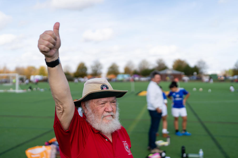 Peter Guthrie signals a teen soccer referee for making a good call during a youth soccer match at Maryland SoccerPlex in Boyds, Md. Guthrie is an instructor with the U.S. Soccer Federation Referee Program.