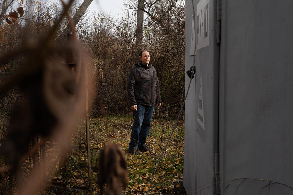 Mykhailo Voinov, an electrician who's been fixing damaged Ukrainian energy infrastructure, looks at a damaged electrical substation in northeast Ukraine's Kharkiv region.
