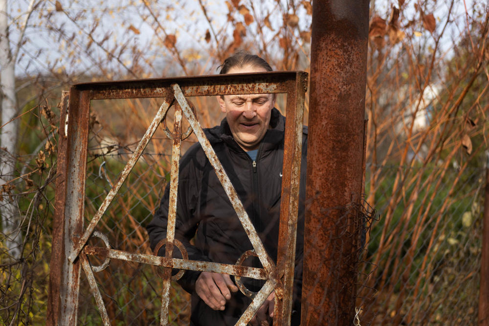 Voinov closes the gate to an electrical substation after looking at the damage.