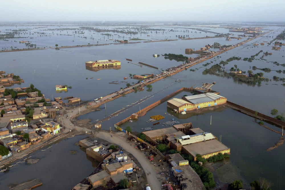 Homes are surrounded by floodwaters in Sohbat Pur city, a district of Pakistan's southwestern Baluchistan province this summer. It is likely that climate change helped drive deadly floods in Pakistan, according to a recent scientific analysis.