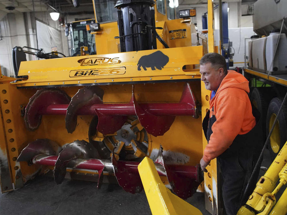 Heavy equipment operator Don Beitz walks around a giant snow thrower while preparing for the impending snowstorm that is expected to dump several feet of snow on the area until Friday evening at the New York State Thruway's Walden Garage in Cheektowaga, N.Y. on Thursday, Nov. 17, 2022.