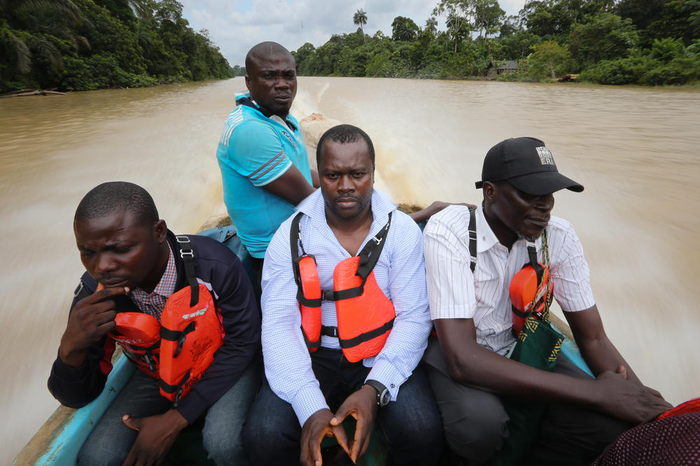 Chima Williams (front and center) takes a tour of an oil-polluted area of the Niger Delta.