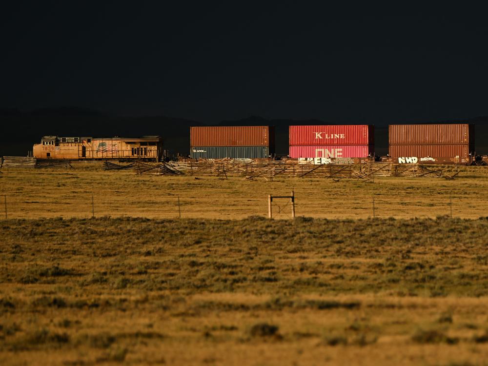 A Union Pacific freight train carries cargo along a rail line at sunset in Bosler, Wyoming, on August 13, 2022.