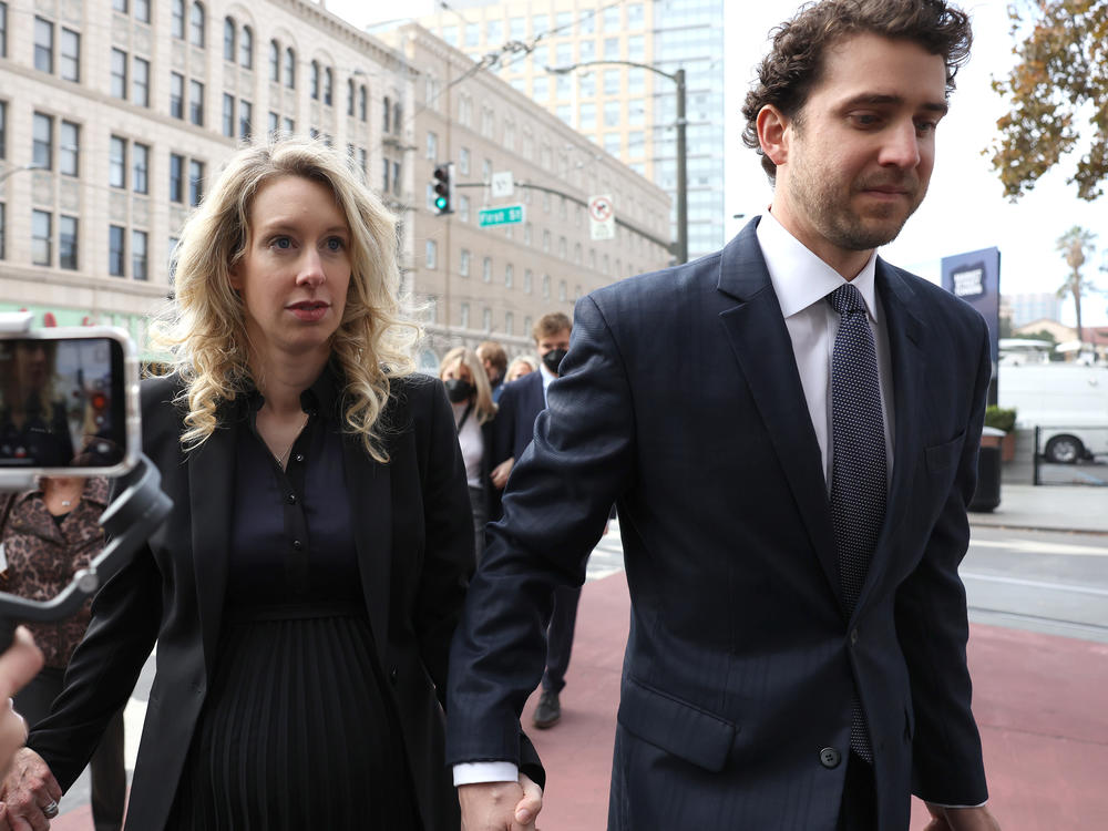 Former Theranos CEO Elizabeth Holmes arrives for her sentencing at federal court with her partner Billy Evans in San Jose, California. Holmes was convicted of four counts of fraud for allegedly engaging in a multimillion-dollar scheme to defraud investors.