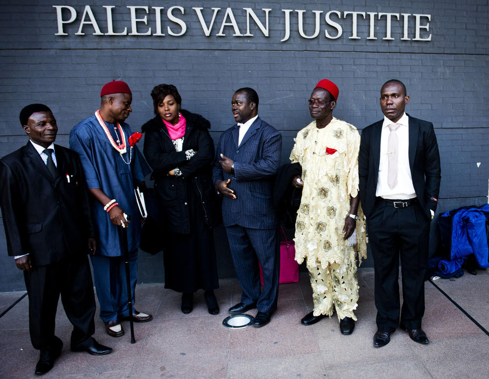 Posing in 2012 at the law courts of the Hague are the four Nigerian farmers who brought their concerns about oil spills to lawyer Chima Williams. Left to right: Farmers Friday Alfred Akpan-Ikot Ada Udo and Eric Dooh; Nini Okey Uche of the Nigerian Embassy; lawyer Chima Williams and farmers Chief Fidelis A. Oguru-Oruma and Alali Efanga.