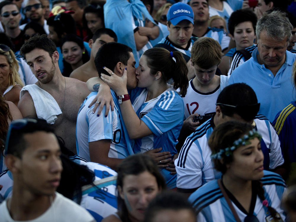 Argentina fans kiss in the crowd while watching the World Cup final in Rio de Janeiro, Brazil in 2014.