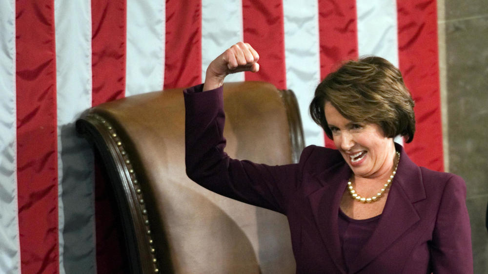 Rep. Nancy Pelosi flexes her muscles before receiving the speaker's gavel from Rep. John Boehner in January 2007 at the start of the 110th Congress, her first as House speaker.