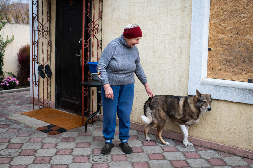 Mariya Kryvoruchko, 70, with her son-in-law's dog, Sana, in recently liberated Kherson on Wednesday.