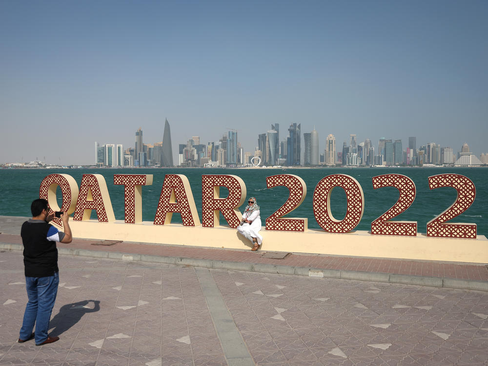 Supporters take photographs in front of 2022 signage ahead of the FIFA World Cup on November 20, 2022 in Doha, Qatar.