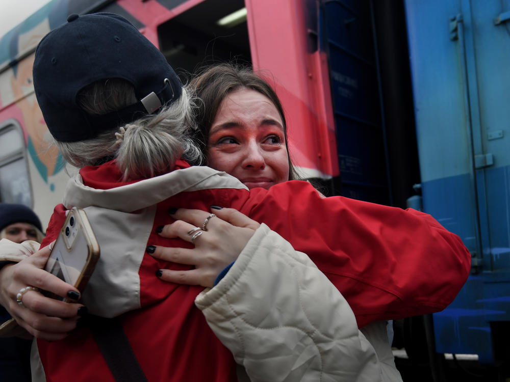 Liudmyla, left, embraces her granddaughter, Ania, who arrived Saturday on the first Ukrainian Railways train to reach liberated Kherson, Ukraine. The train from Kyiv arrived to jubilation and tears.
