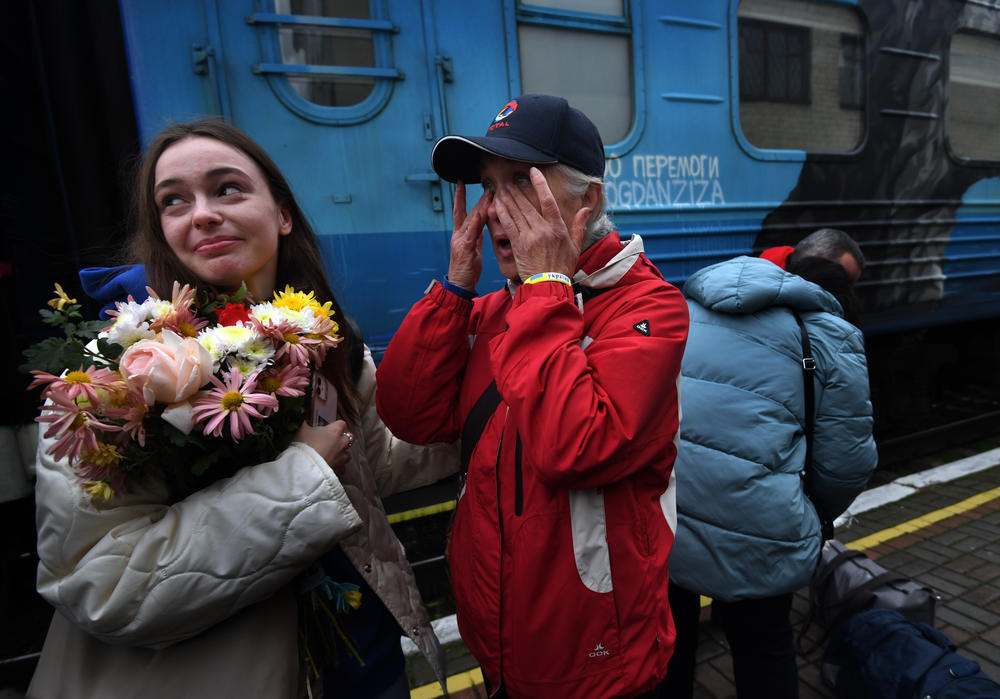 Liudmyla, center, wipes her eyes and welcomes her granddaughter, Ania, who arrived Saturday on the first Ukrainian Railways train to reach liberated Kherson.