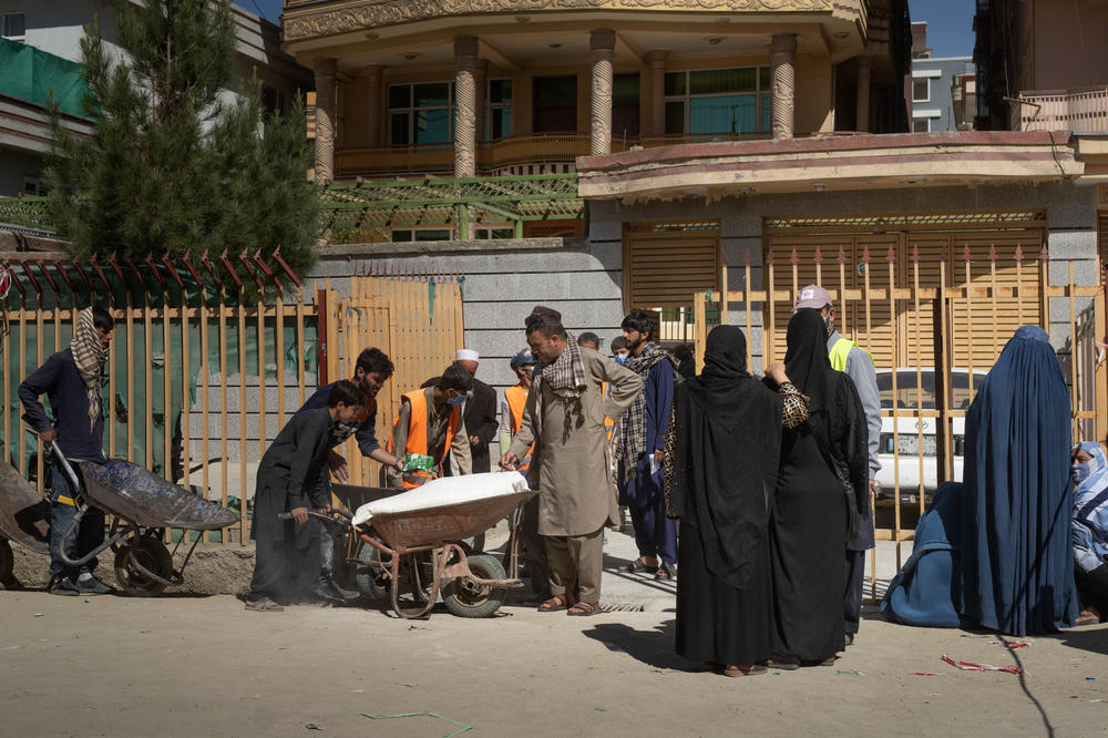 Women wait outside the distribution center where the World Food Programme is giving food assistance in October.