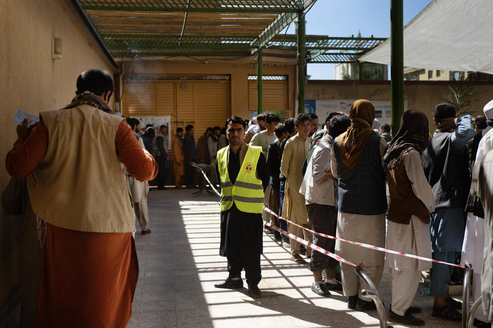 Lines of people snake through the courtyard of a food distribution center in Kabul in October.