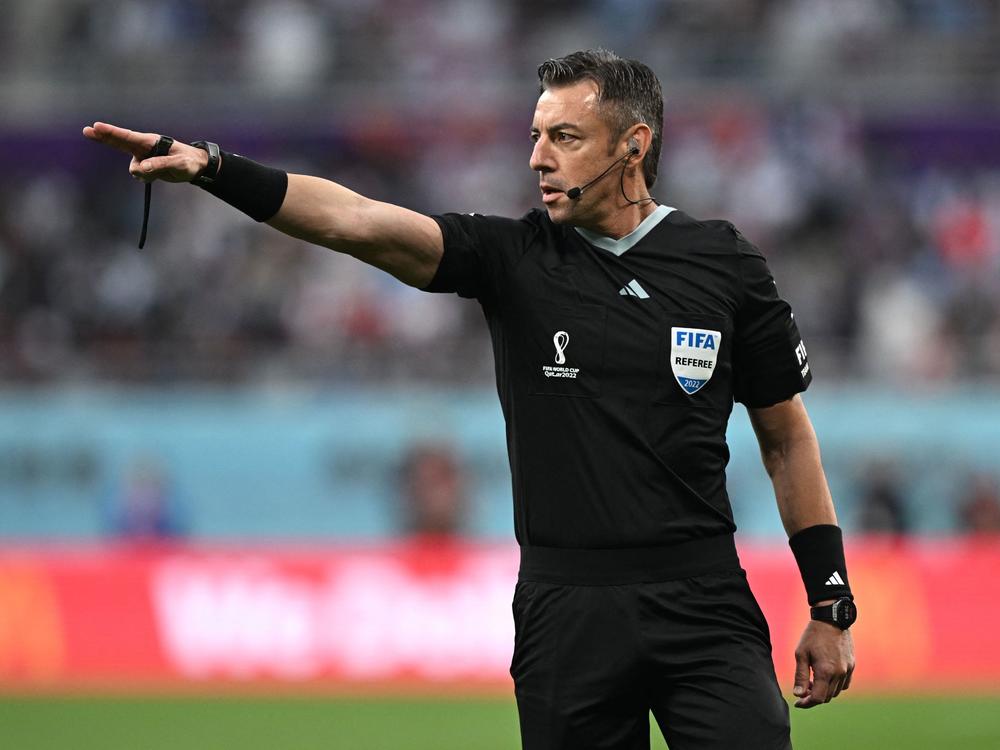 Brazilian referee Raphael Claus gestures during the Qatar 2022 World Cup soccer match between England and Iran at the Khalifa International Stadium in Doha on Monday. Claus added 29 minutes of stoppage time to the game - part of a growing trend at this tournament.