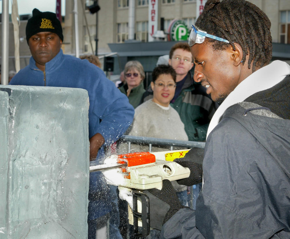 Kenyan ice-carving team of Michael Kaloki (left) and Peter Walala, seen here working the ice in Toronto, represented Africa at Quebec's 2003 Winter Carnival and spread their message about climate change.