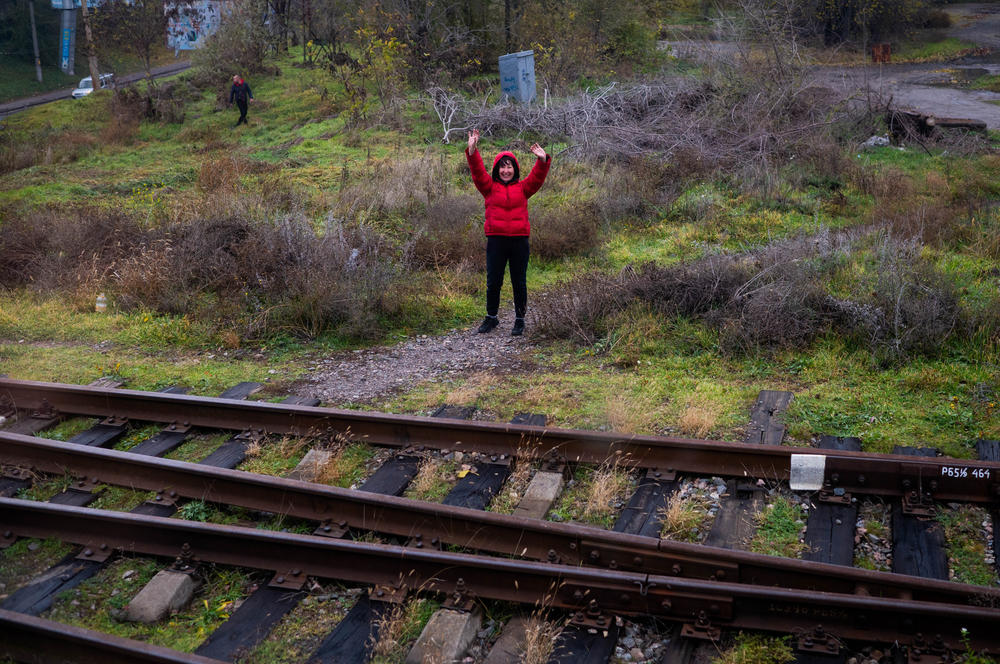 A woman waves to the train.