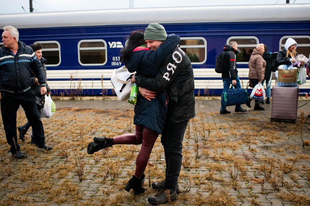 People greet each other on the platform as a train bound for Kherson makes a stop in Mykolaiv on Saturday.