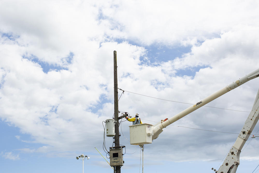 Contractors for the island's electric utility company worked to restore power in Lajas last month.