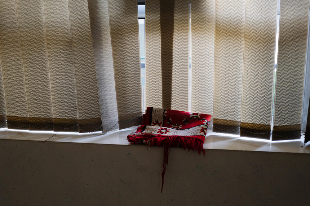 A prayer rug sits on a window sill in a location where the ex-commando sometimes stays.