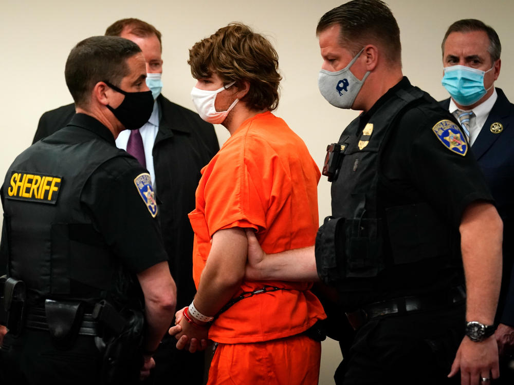 Payton Gendron is led out of the courtroom after a hearing in Buffalo, N.Y., on May 19. Gendron faces charges in the May 14 fatal shooting at a supermarket.