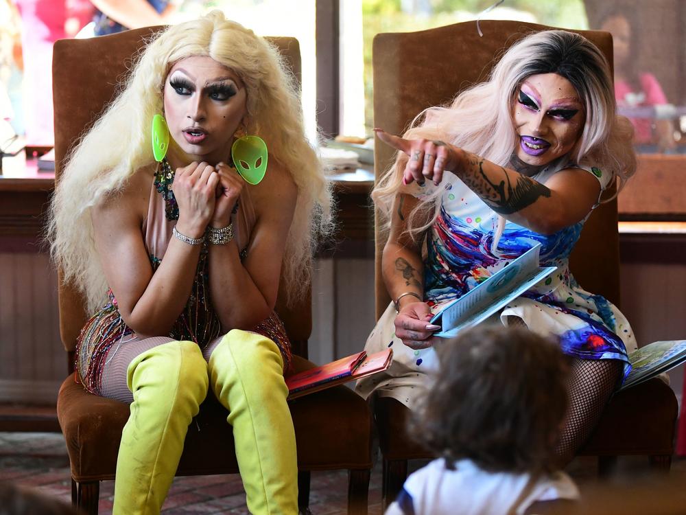 Athena Kills (left) and Scalene Onixxx are pictured during Drag Queen Story Hour in Riverside, Calif. The rise of family-friendly drag events has sparked a backlash among right-wing media and organizers.