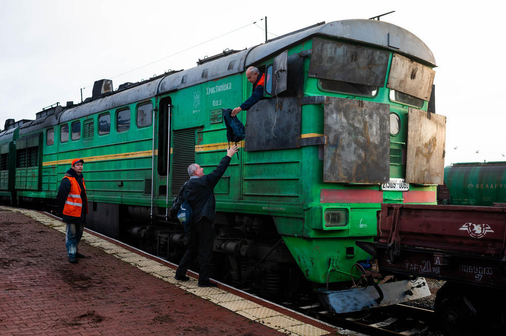 Ukrainian Railways staff prepare for departure from Mykolaiv on the train headed to Kherson. The train was fitted with improvised armor and pushed empty cars ahead of it as precautionary measures.