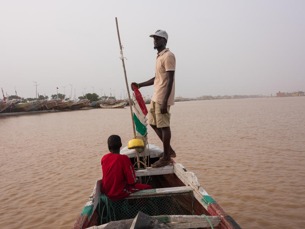 Moustapha Dieye on his boat in Guet Ndar, Senegal on October 5. Dieye took a pirogue to Spain in 2006, where he now legally resides. His family has a boat in Saint Louis, where he is originally from.