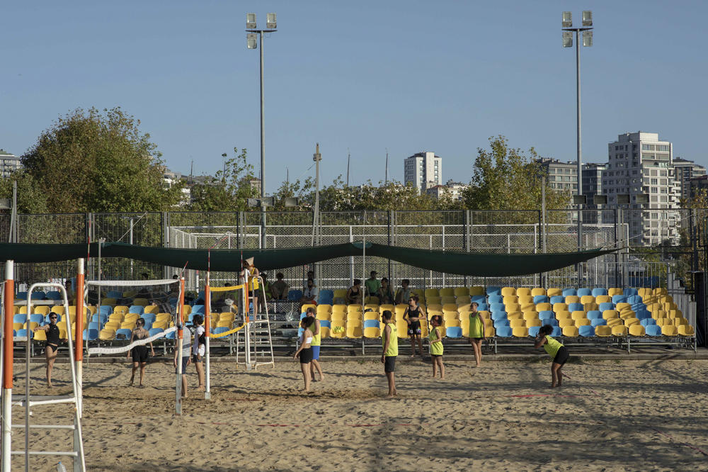 A beach volleyball game during Queer Olympix VI in Istanbul in September 2022. In the background, the stands are mostly empty. The Queer Olympix were banned by police in 2019; since then, the event has been organized in secrecy, with participants made aware only via invitation.
