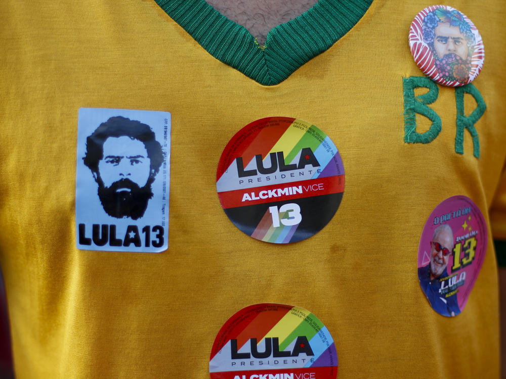 A supporter of Brazilian President-elect Luiz Inácio Lula da Silva wears a shirt with election campaign stickers during the runoff vote in Rio de Janeiro, Oct. 30.