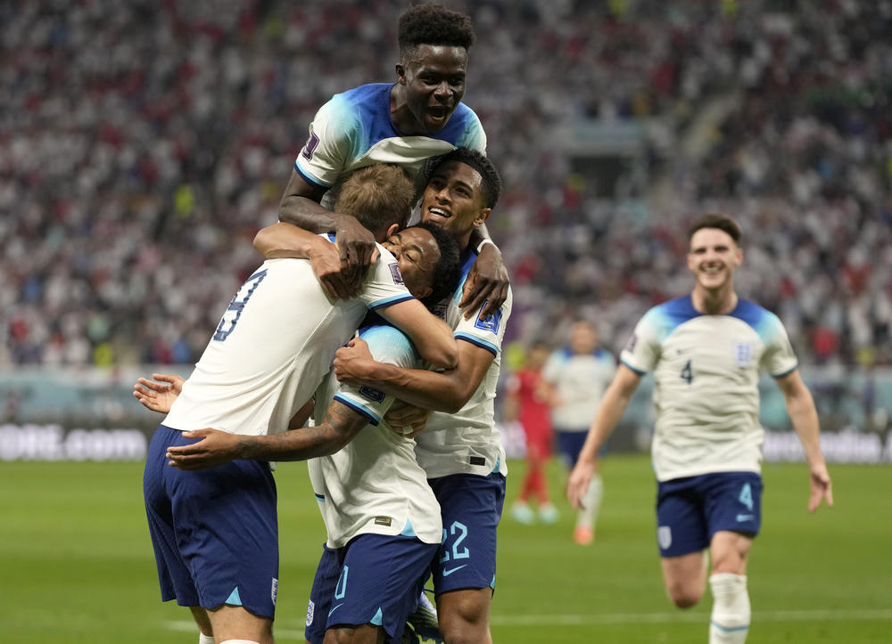 England's Raheem Sterling celebrates with his teammates after scoring his side's third goal during a 2022 World Cup Group B soccer match with Iran on Monday, Nov. 21, 2022, at the Khalifa International Stadium in Doha, Qatar.