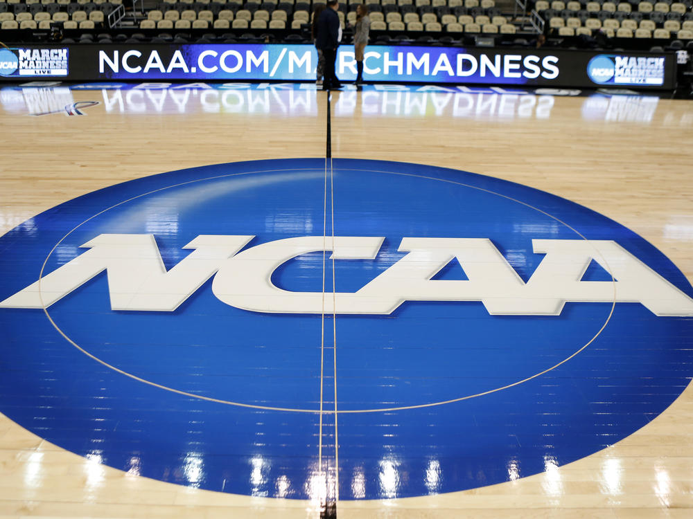 In this March 18, 2015, file photo, an NCAA logo is displayed at center court as work continues at The Consol Energy Center in Pittsburgh, for the NCAA college basketball second and third round games.