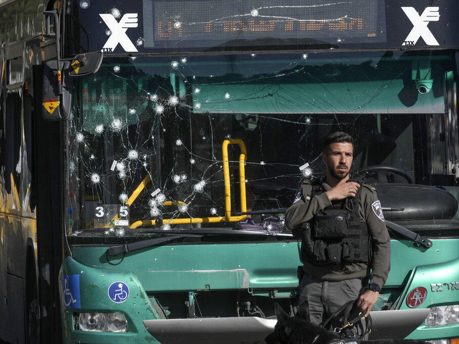 Israeli police inspect the scene of an explosion Wednesday at a bus stop in Jerusalem.