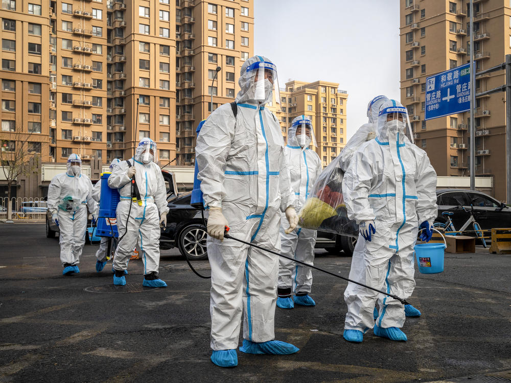 Workers wear protective gear in a Beijing neighborhood placed under lockdown in November. China had raised hopes by slightly relaxing its zero-COVID policy, but cities have been contending with a surge in cases.