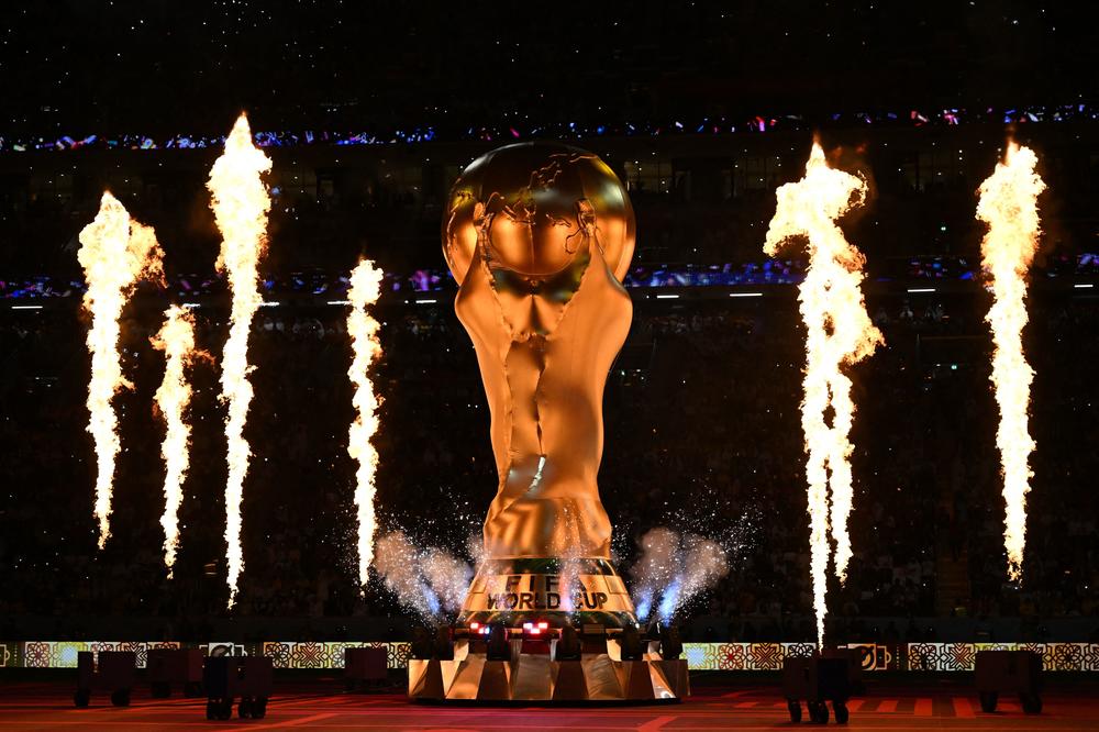 Fireworks explode around a replica of the FIFA World Cup trophy during the opening ceremony ahead of a Group A match between Qatar and Ecuador at the Al-Bayt Stadium in Al Khor, north of Doha, Qatar, on Sunday, Nov. 20, 2022.