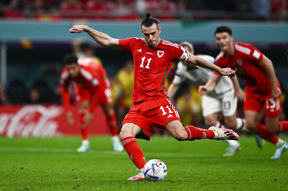 Wales forward Gareth Bale (No. 11) takes a penalty to score his team's first goal during a 2022 World Cup Group B match agains the U.S. on Monday, Nov. 21, 2022, at the Ahmad Bin Ali Stadium in Al-Rayyan, west of Doha, Qatar.