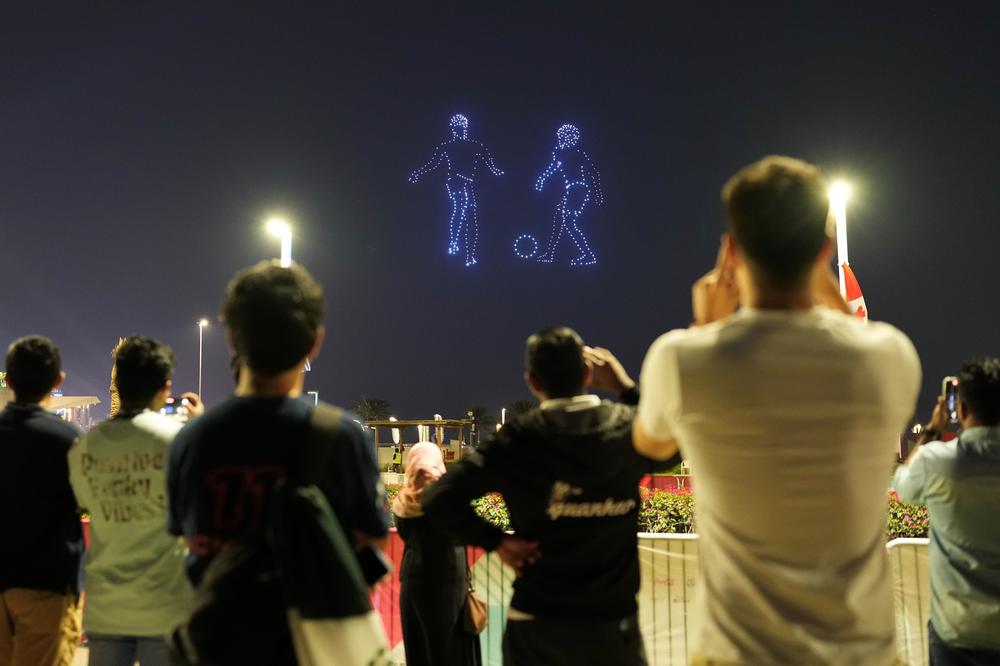 Fans take photos of fireworks over the Doha skyline during Day 2 of the 2022 FIFA World Cup's fan festival at Al Bidda Park on Sunday, Nov. 20, 2022.