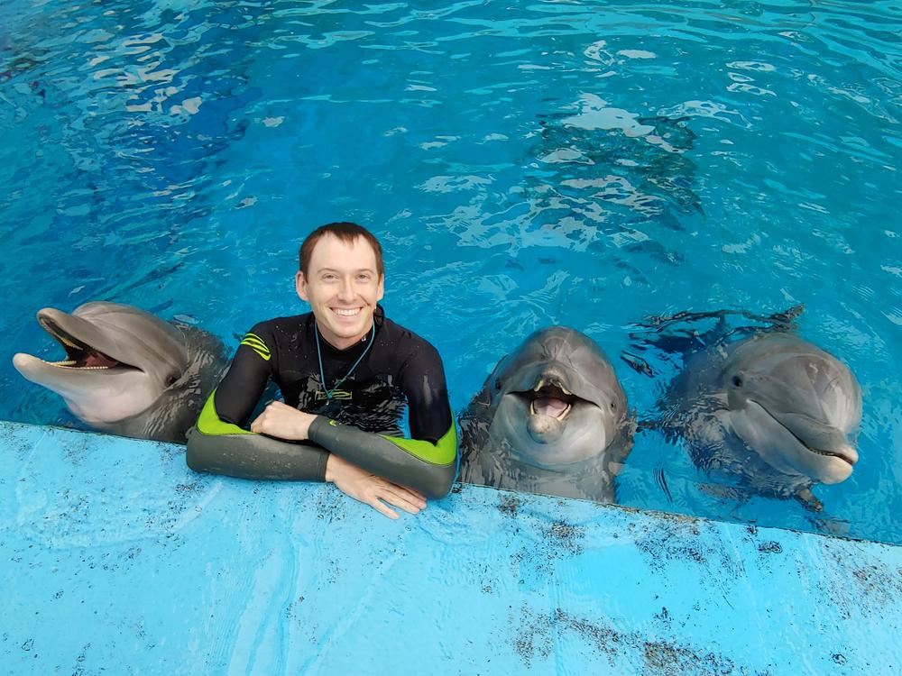 Kenneth Reese swimming with dolphins