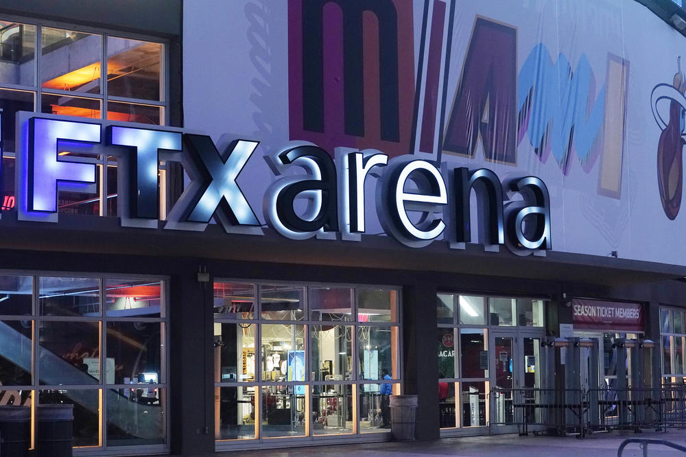 Signage for the FTX Arena, where the Miami Heat basketball team plays, is seen illuminated on Saturday. The rapid collapse of cryptocurrency exchange FTX into bankruptcy has driven arena owner Miami-Dade County to seek a break in its naming rights deal with FTX.