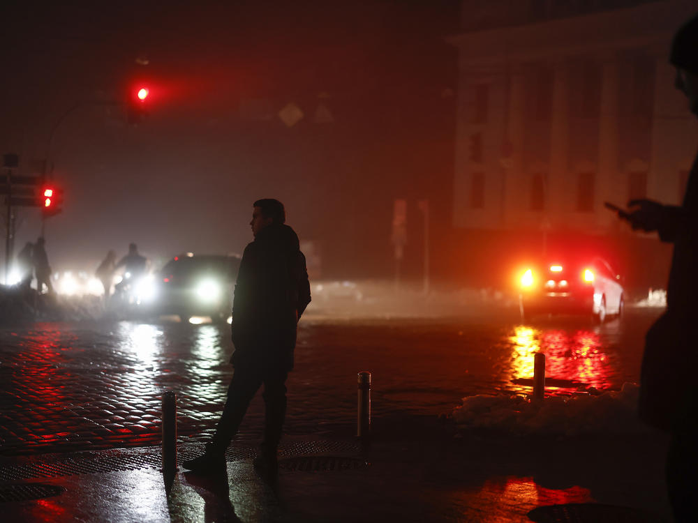 Ukrainians walk through the unlit streets of the capital Kyiv on Thursday, a day after Russian airstrikes knocked out electricity, heating and water to much of the country. With Russian troops faring poorly on the battlefield, Russia has launched a widespread bombing campaign directed at civilian infrastructure in Ukraine.