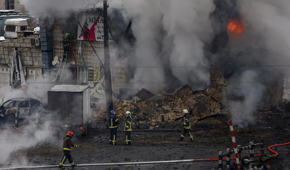 Ukrainian firemen put out a blaze at a building hit by a Russian missile in Kyiv. Russia fired 70 missiles at Ukraine on Wednesday the latest barrage in a stepped up air campaign against the country's civilian infrastructure.