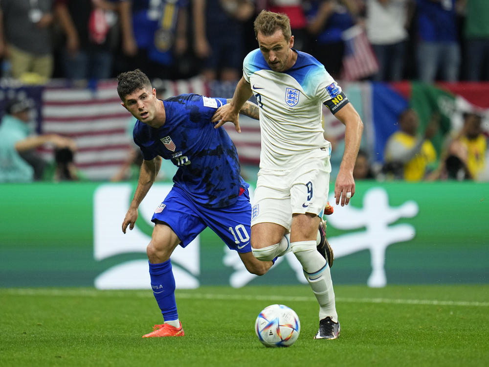 England's Harry Kane, right, fights for the ball against Christian Pulisic of the United States during the World Cup group B soccer match at the Al Bayt Stadium in Al Khor, Qatar, on Friday.