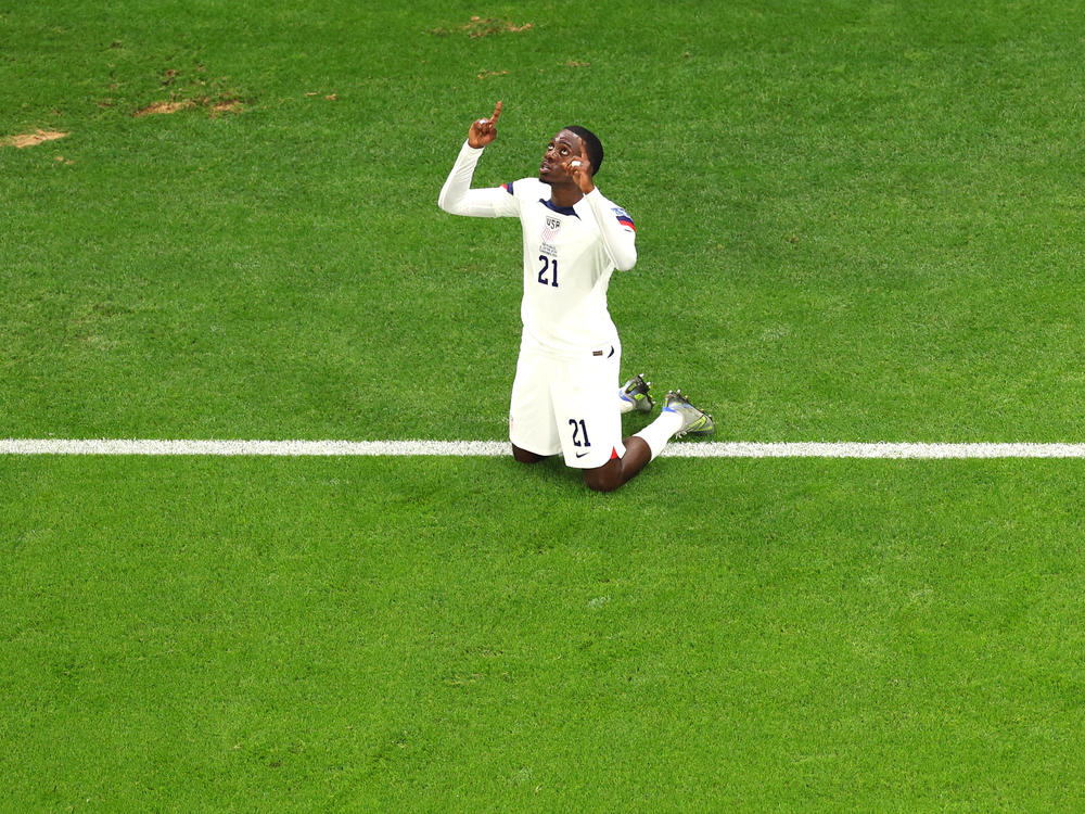 Tim Weah points to the sky after scoring the first U.S. goal of the 2022 World Cup against Wales on November 21, 2022.