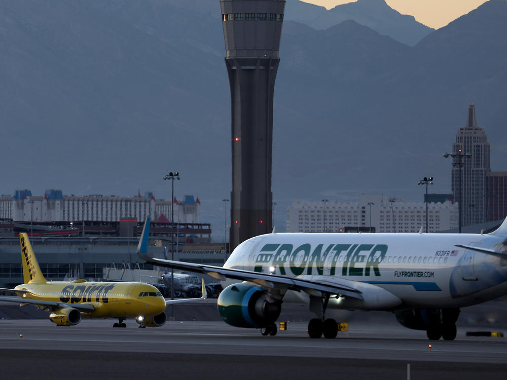 A Frontier Airlines plane  prepares to take off from Harry Reid International Airport in Las Vegas, Nevada.